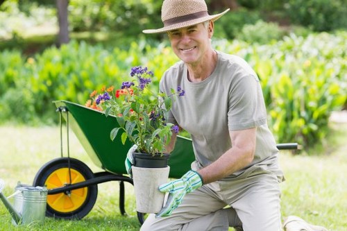 Worker demonstrating safe lifting techniques with a wheelbarrow