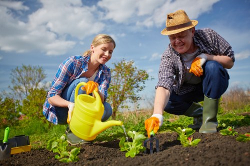 Gardener inspecting plants and taking notes