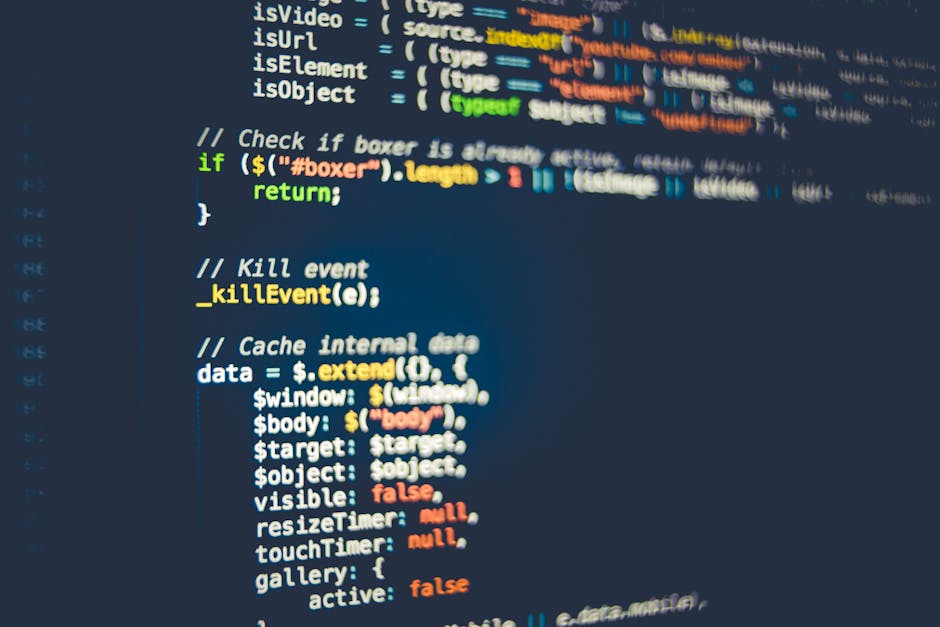 A close-up digital photograph of a computer screen displaying lines of HTML and CSS code in a code editor, with the code highlighting the structure of a webpage. The screen shows tags such as <html>, 